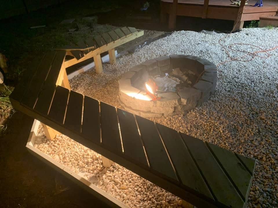 Fire pit and benches we built, lit at night